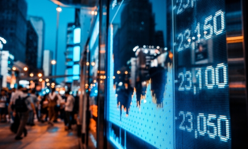 Display of Stock market quotes with city scene reflect on glass