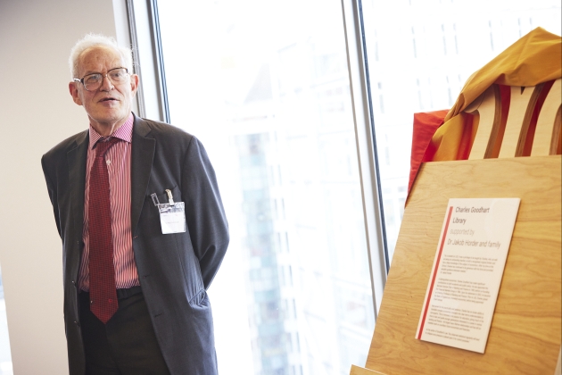 Charles Goodhart speaking in front of unveiled easel inaugurating the Charles Goodhart Library